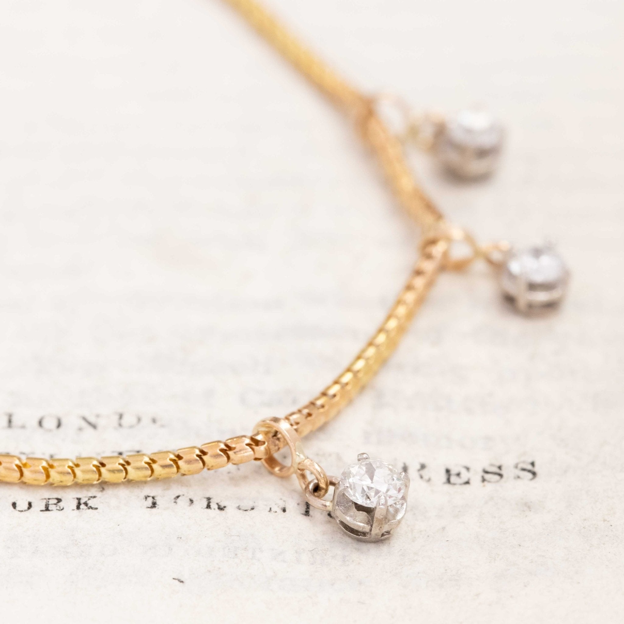 Heirloom diamond station necklace, 14-inch yellow gold chain with sparkling antique old European cut diamonds.