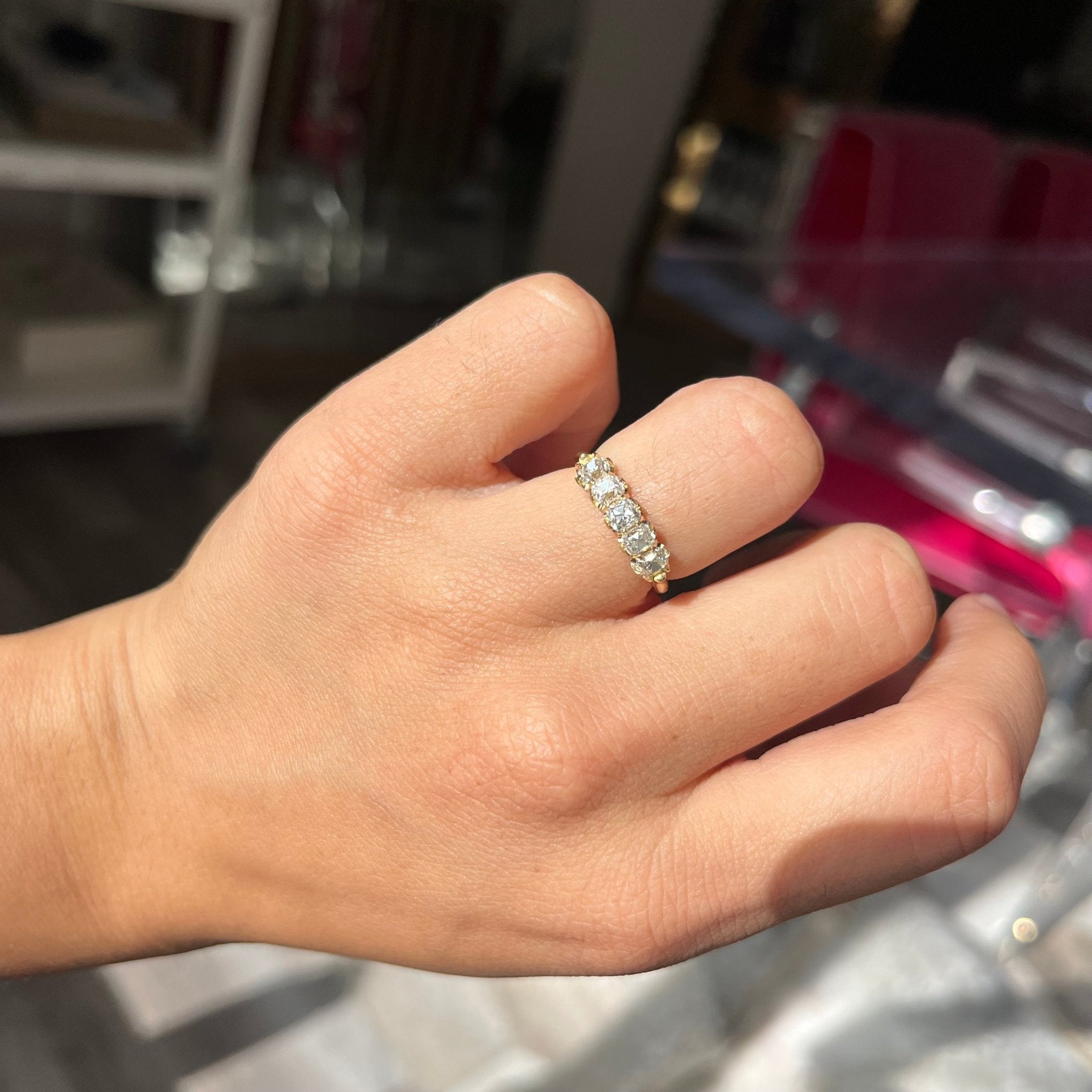 Elegant 1.00ctw Old Mine Cut Diamond 5-Stone Half-Hoop Band, romantic design with Old Mine Cut Diamonds, Earth-mined diamonds in yellow gold shown on ring finger