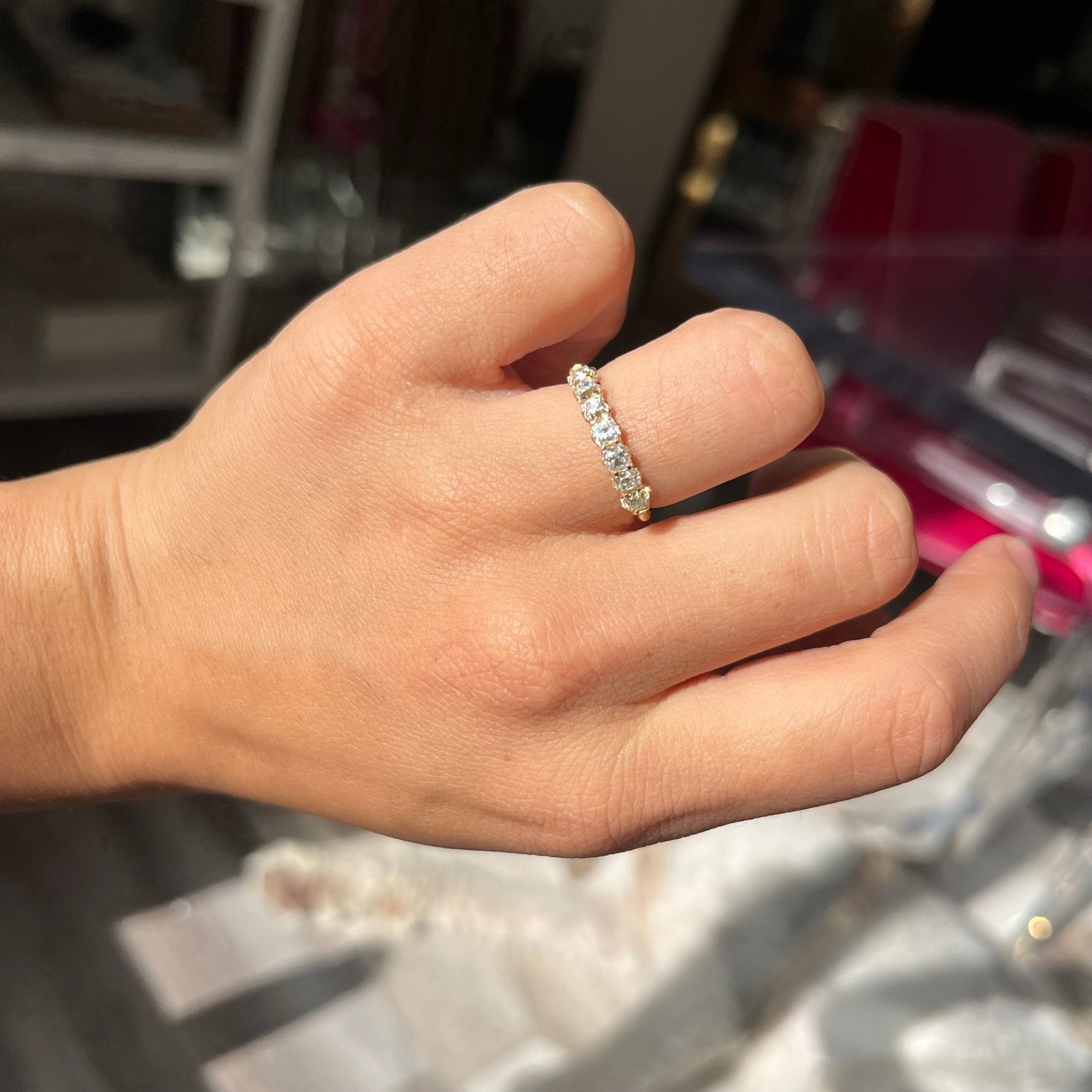 Elegant 1.00ctw Old Mine Cut Diamond 7-Stone Half-Hoop Band, romantic design with Old Mine Cut Diamonds, Earth-mined diamonds in yellow gold shown on ring finger