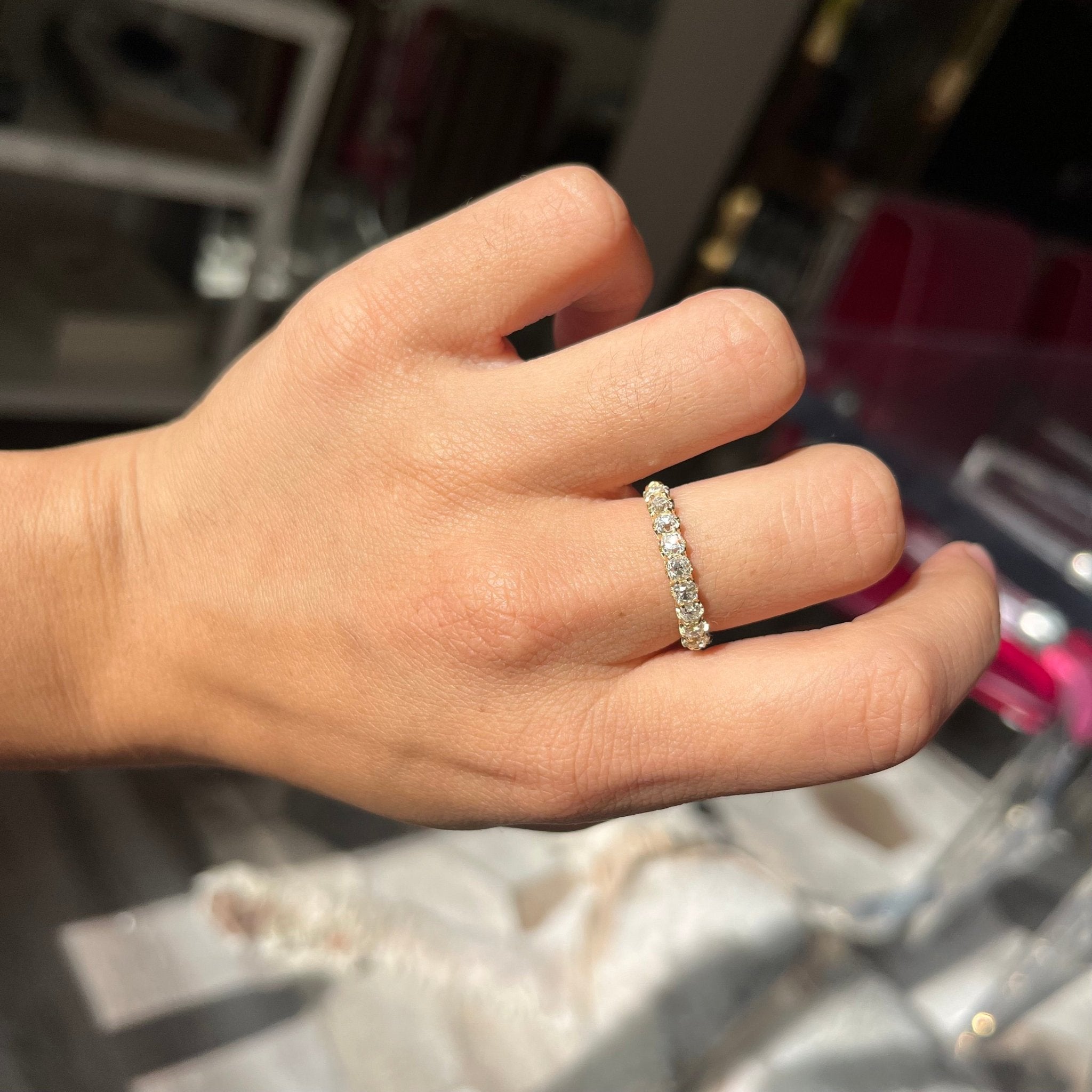 Elegant 1.01ctw Old Mine Cut Diamond Half-Hoop 9-Stone Band, romantic design with Old Mine Cut Diamonds, Earth-mined diamonds in yellow gold shown on ring finger