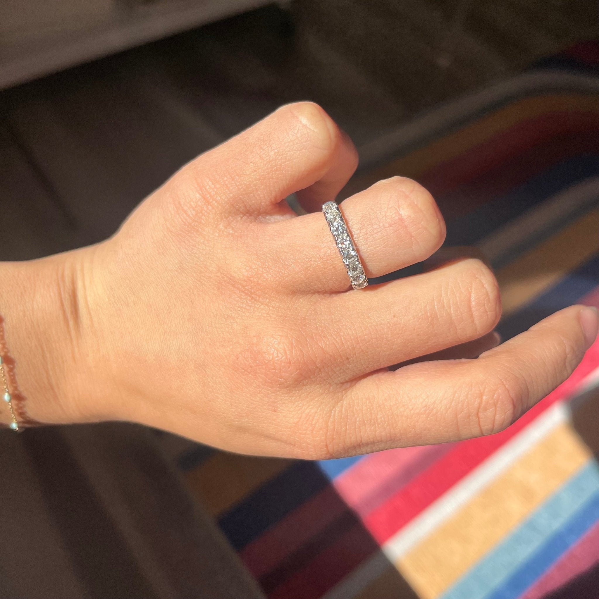 Elegant 1.03ctw Old European Cut Diamond Yin-Yang Half Eternity Band, romantic design with Old European Cut Diamonds, Earth-mined diamonds in platinum and yellow gold shown on ring finger