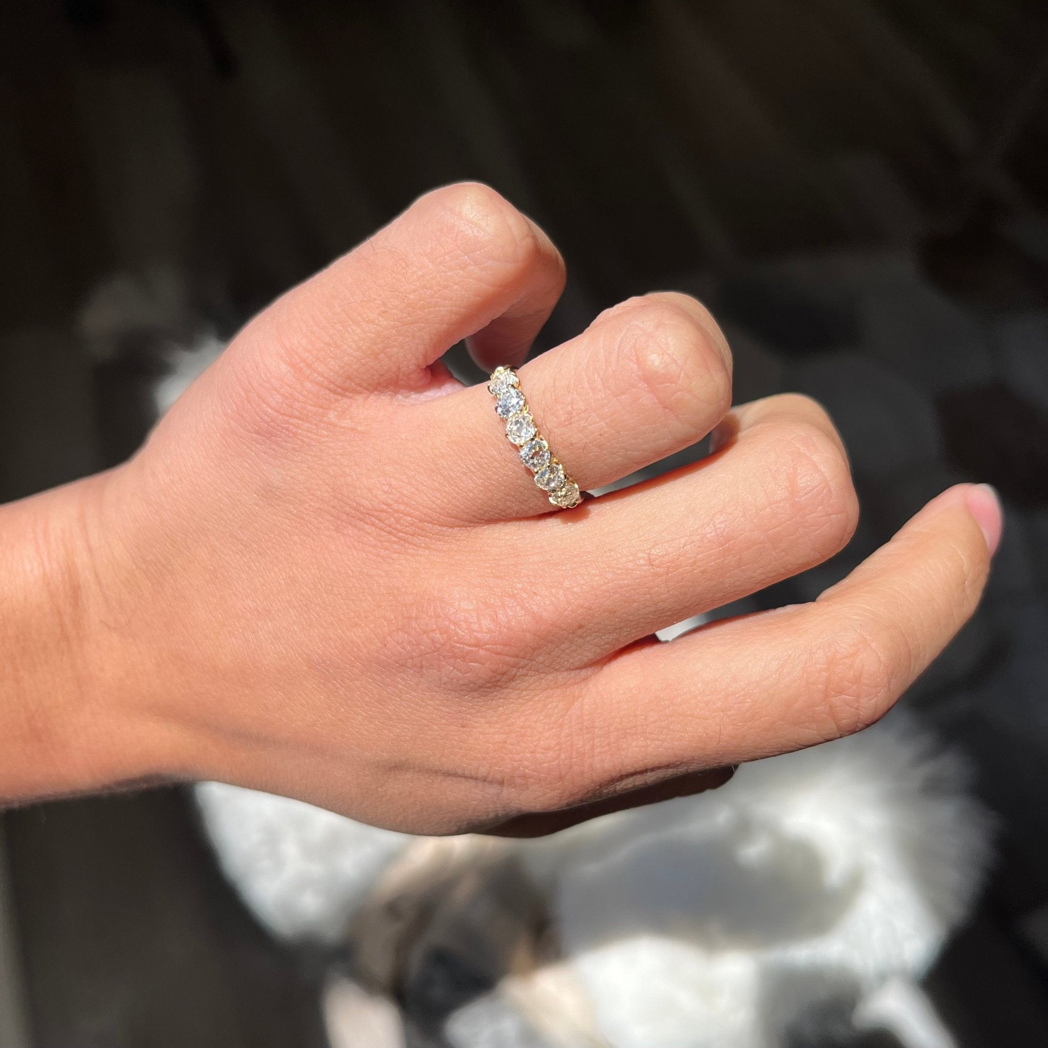 Elegant 1.05ctw Old Mine Cut Diamond 6-Stone Band, romantic design with Old Mine Cut Diamonds, Earth-mined diamonds in yellow gold shown on ring finger