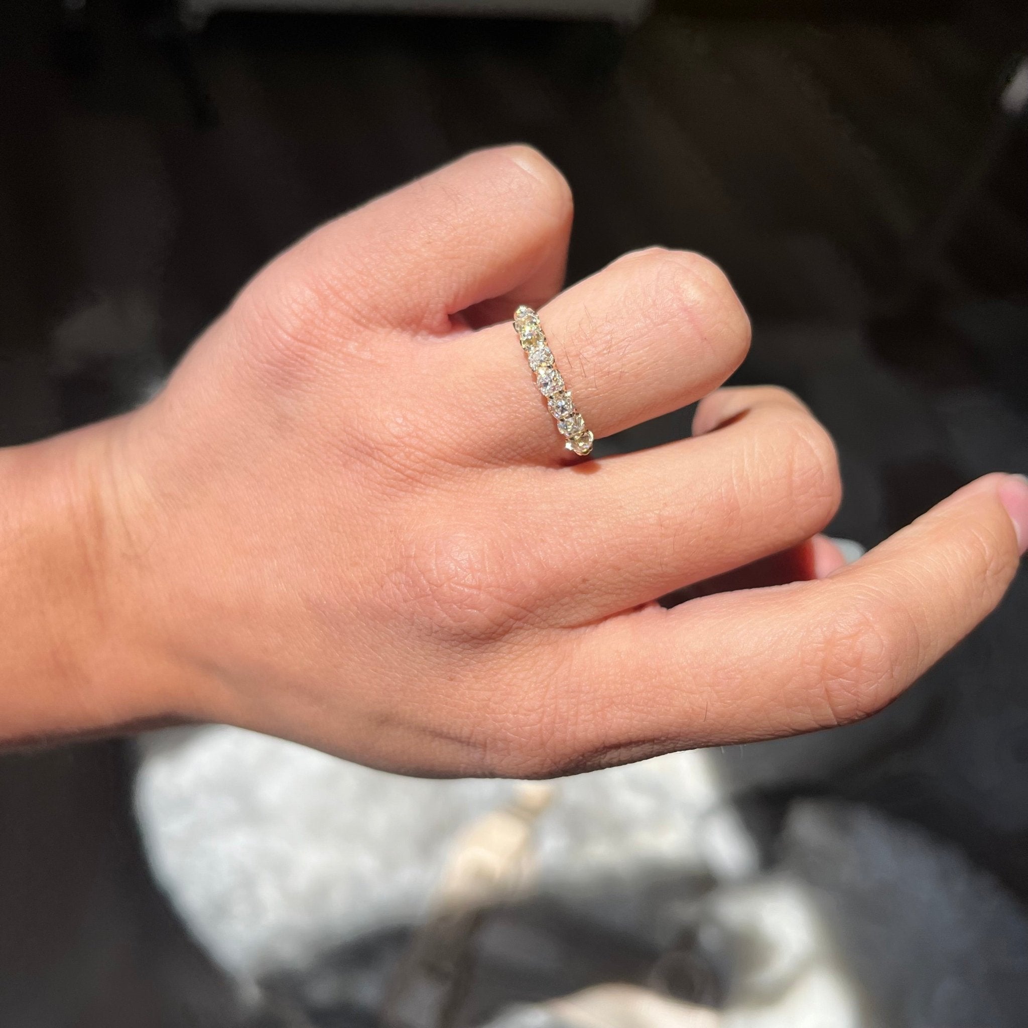 Elegant 1.05ctw Old Mine Cut Diamond Half-Hoop Band, romantic design with Old Mine Cut Diamonds, Earth-mined diamonds in yellow gold shown on ring finger