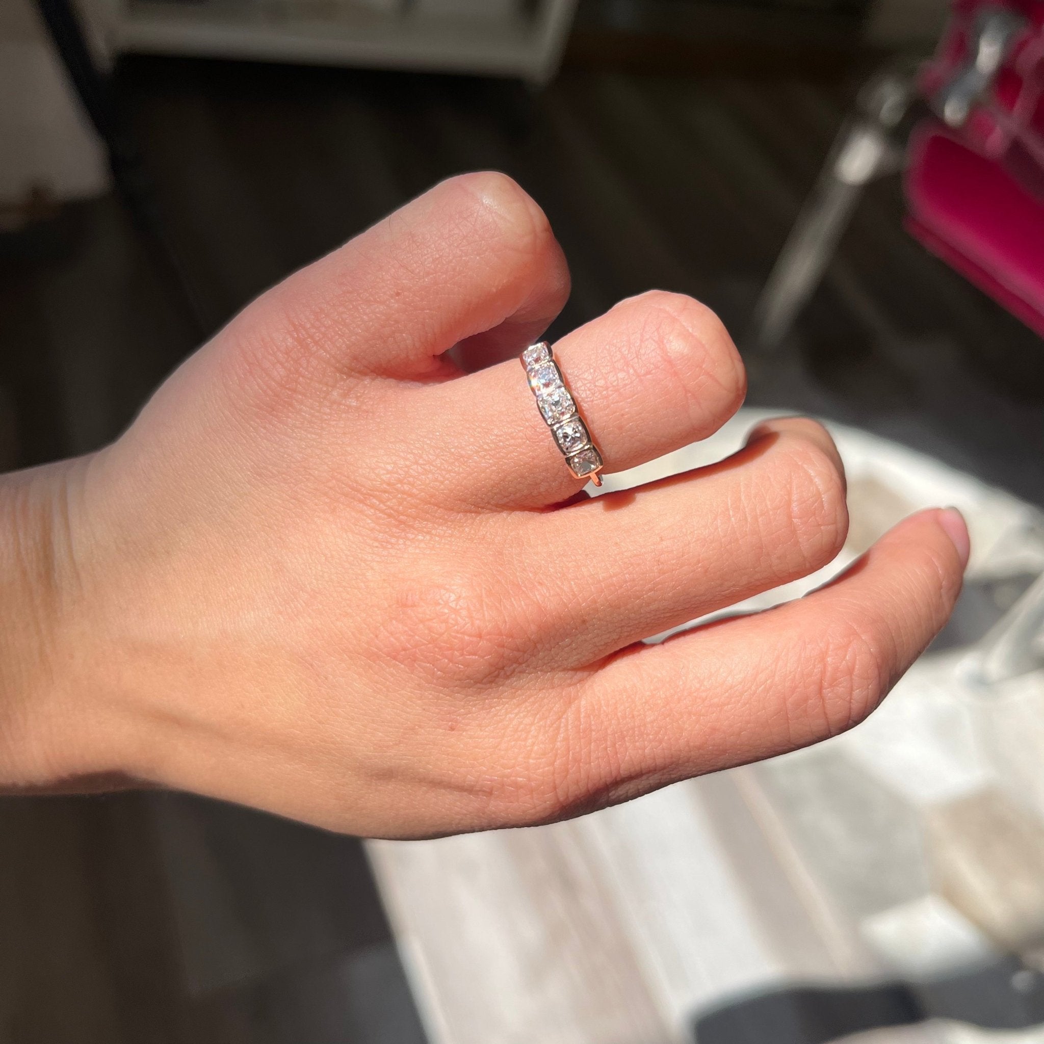 Elegant 1.07ctw Old Mine Cut Diamond 5-Stone Bezel Band, romantic design with Old Mine Cut Diamonds, Earth-mined diamonds in rose gold shown on ring finger