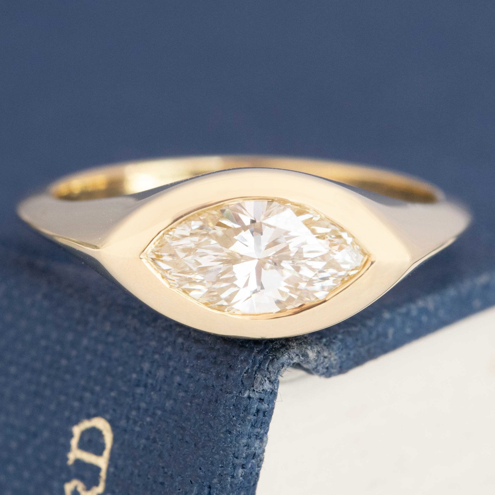 1.11ct marquise cut diamond bezel solitaire ring in 18kt yellow gold, front view