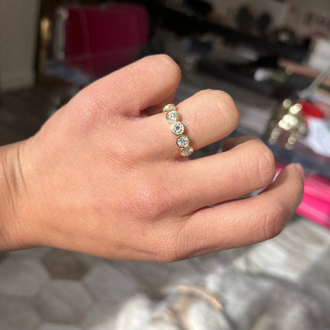 Elegant 1.11ctw Old European Cut Diamond 5-Stone Bezel Band, romantic design with Old European Cut Diamonds, Earth-mined diamonds in yellow gold shown on Ring finger