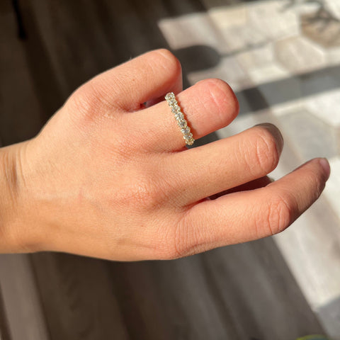 Elegant 1.13ctw Old Mine Cut Diamond Half-Hoop 9-Stone Band, romantic design with Old Mine Cut Diamonds, Earth-mined diamonds in yellow gold shown on ring finger