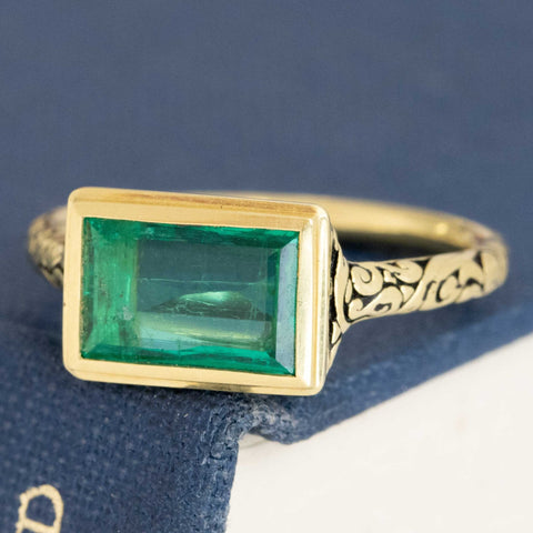 1.18ct Colombian emerald set east-west in a chunky bezel ring with darkened engraved shoulders, 18K yellow gold – alternate view 5