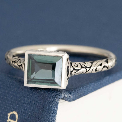 1.20ct color changing sapphire set east-west in a chunky bezel ring with darkened engraved shoulders – alternate view 4