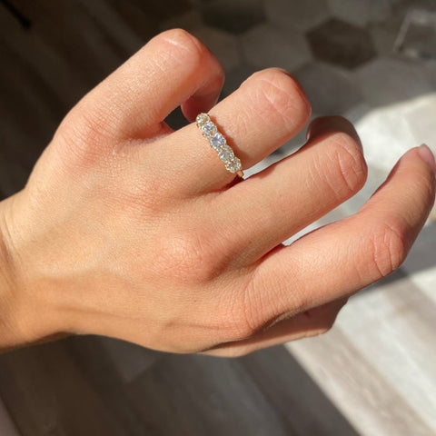 Elegant 1.24ctw Old Mine Cut Diamond 5-Stone Band, romantic design with Old Mine Cut Diamonds, Earth-mined diamonds in yellow gold shown on ring finger