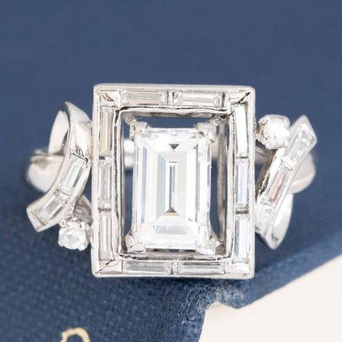 1.39ctw baguette cut diamond center in a geometric step cut frame ring, platinum