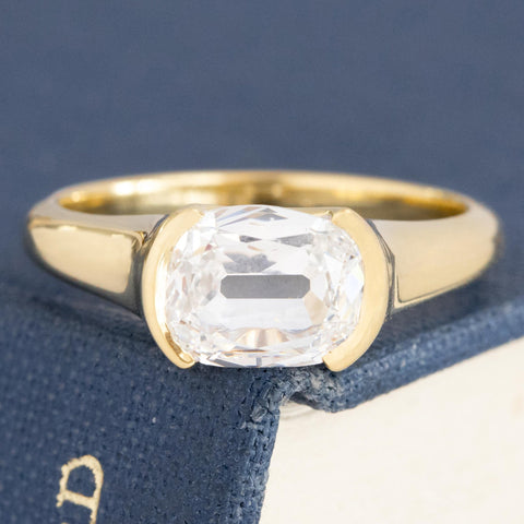 1.50ct GIA E SI2 elongated cushion cut diamond east-west half-bezel solitaire, 18K yellow gold