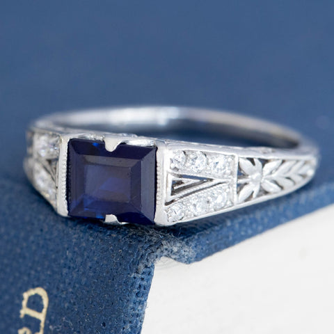 East-west rectangular sapphire ring with intricate platinum filigree