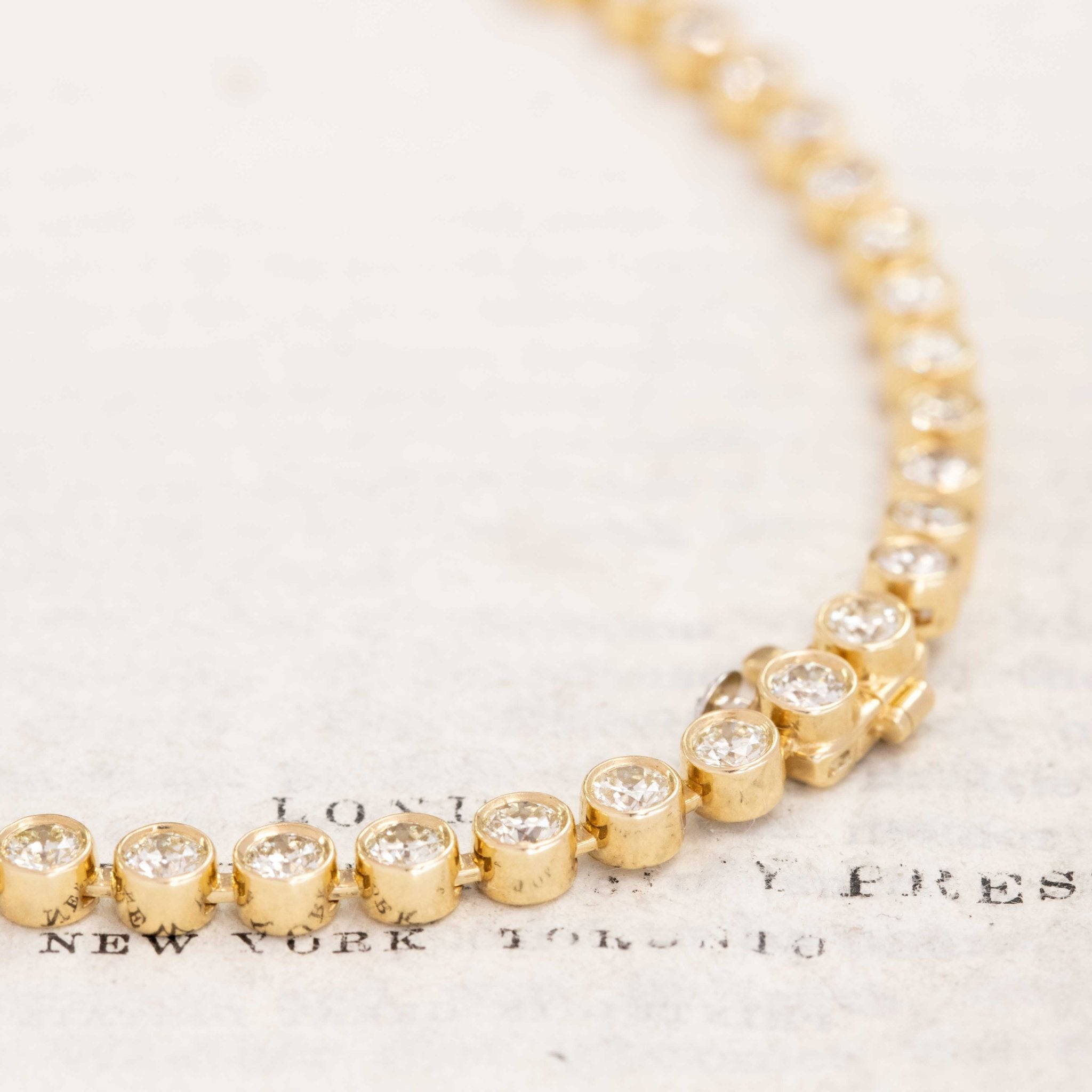 Statement necklace in 18k yellow gold with alternating OEC diamonds, vintage-inspired design.