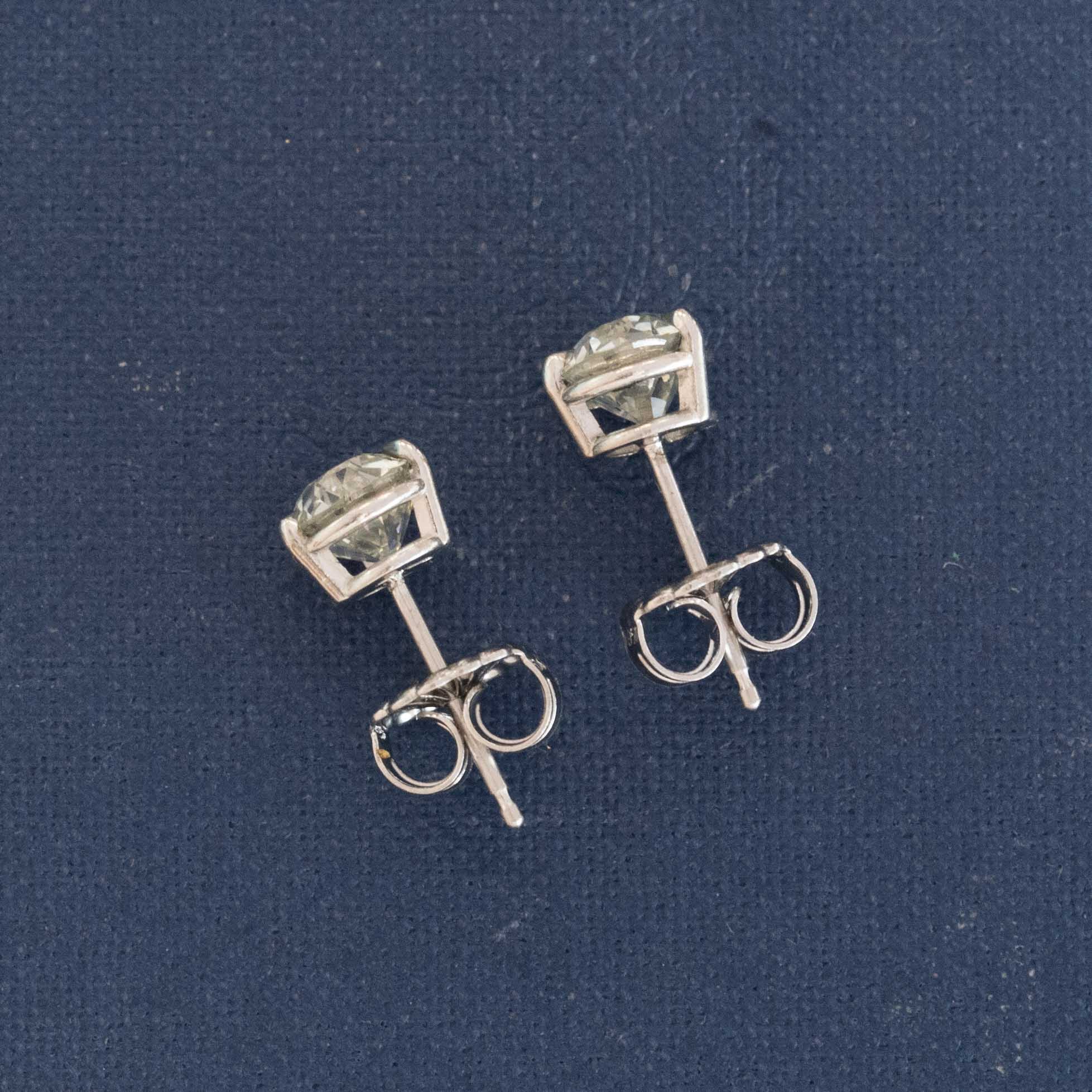 profile of vintage diamond stud earrings platinum GIA certified old european cut