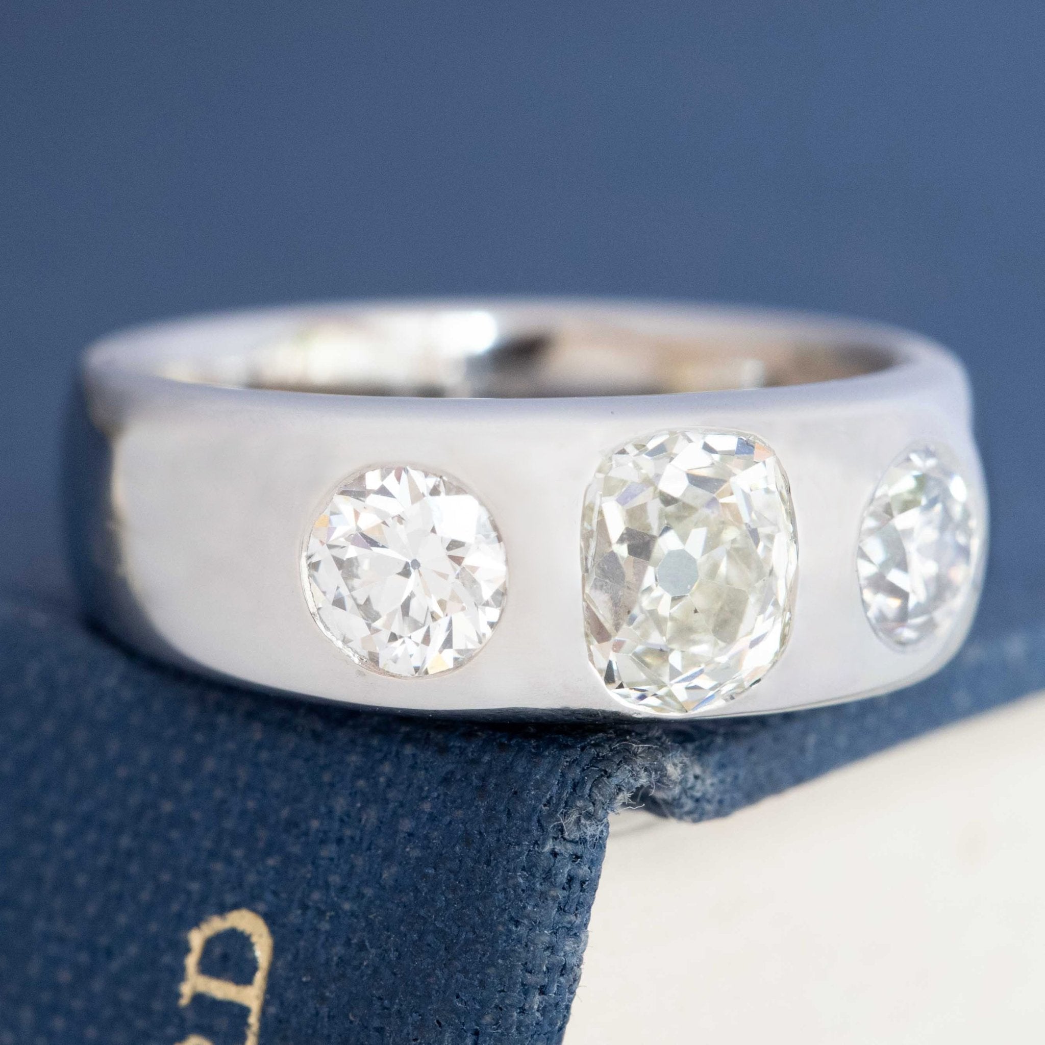 Antique sparkle three-stone ring, soft glow vintage diamonds