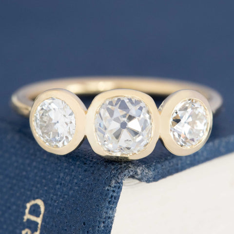 1.86ctw old mine cut and old European cut diamond bezel trilogy ring, 1.05ct center, 18K yellow gold