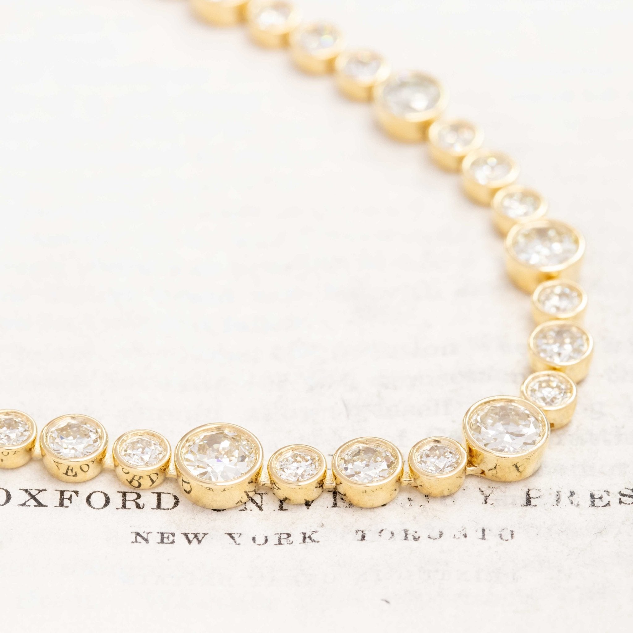 Riviere with bezel set old European cut diamonds in varying sizes in yellow gold.  The differing sizes give the piece a more contemporary feel yet so unique in that the diamonds are all vintage diamonds.