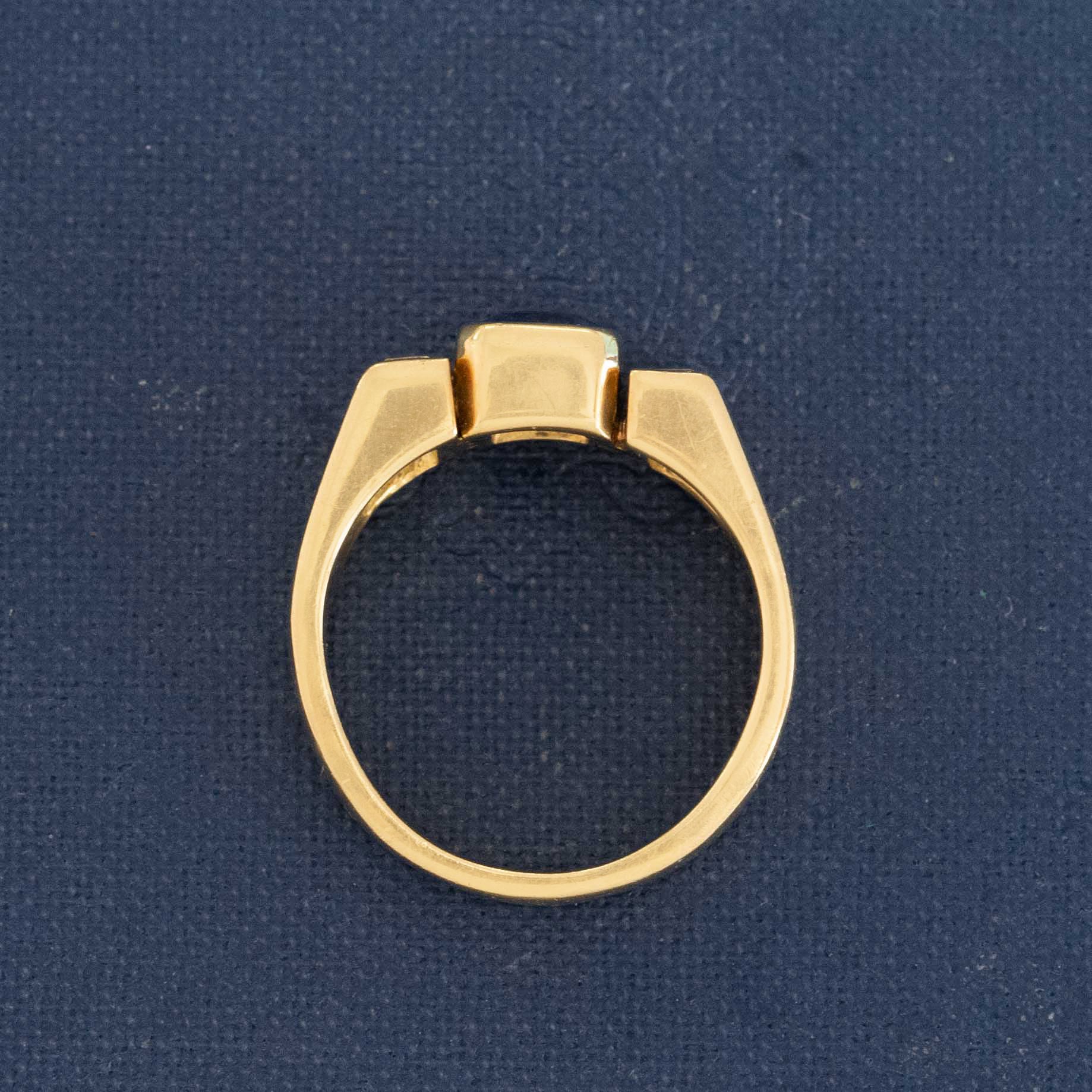 Profile view showing chunky band design of yellow gold sapphire diamond trilogy ring