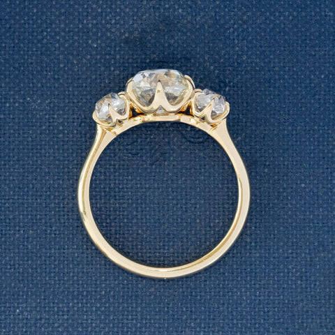 Side profile of Heirloom-quality three-stone diamond ring featuring antique diamonds