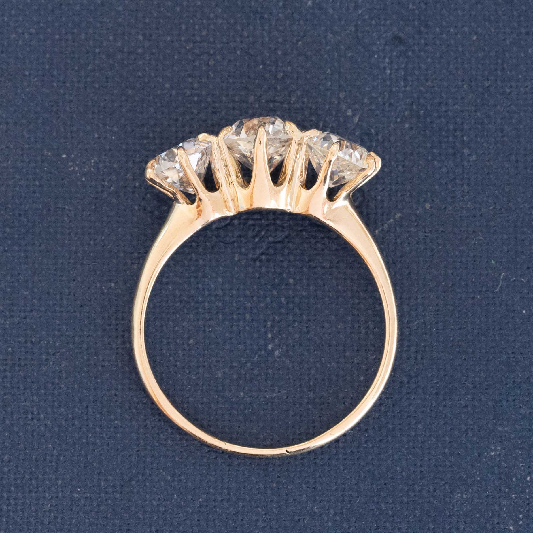 A antique 3-stone ring set with chunky old mine cut diamonds in a rosy yellow gold. Perfect vintage engagement ring choice,