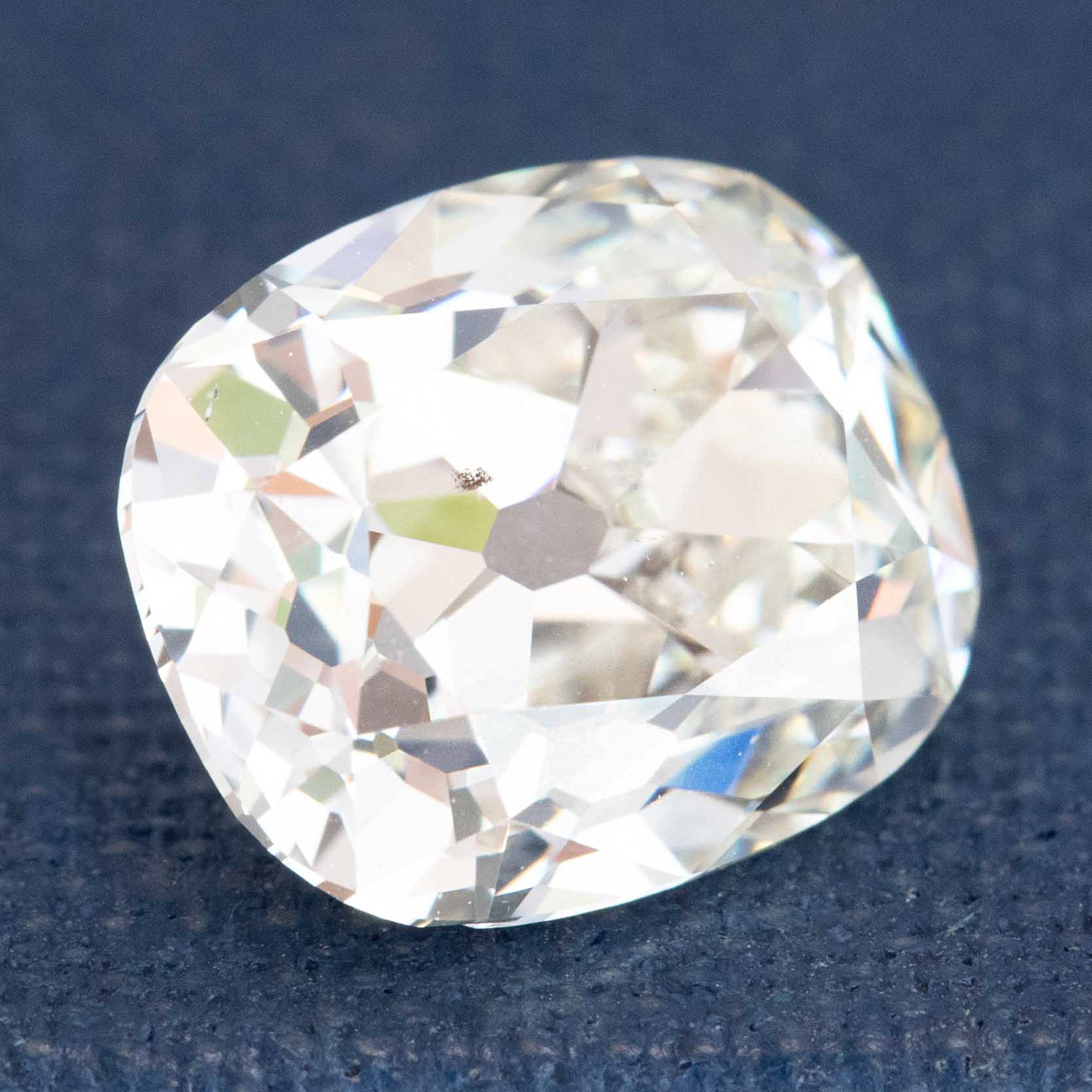 Close-up of antique elongated Old Mine Cut diamond facets
Antique diamond with elongated shape and visible Maltese cross