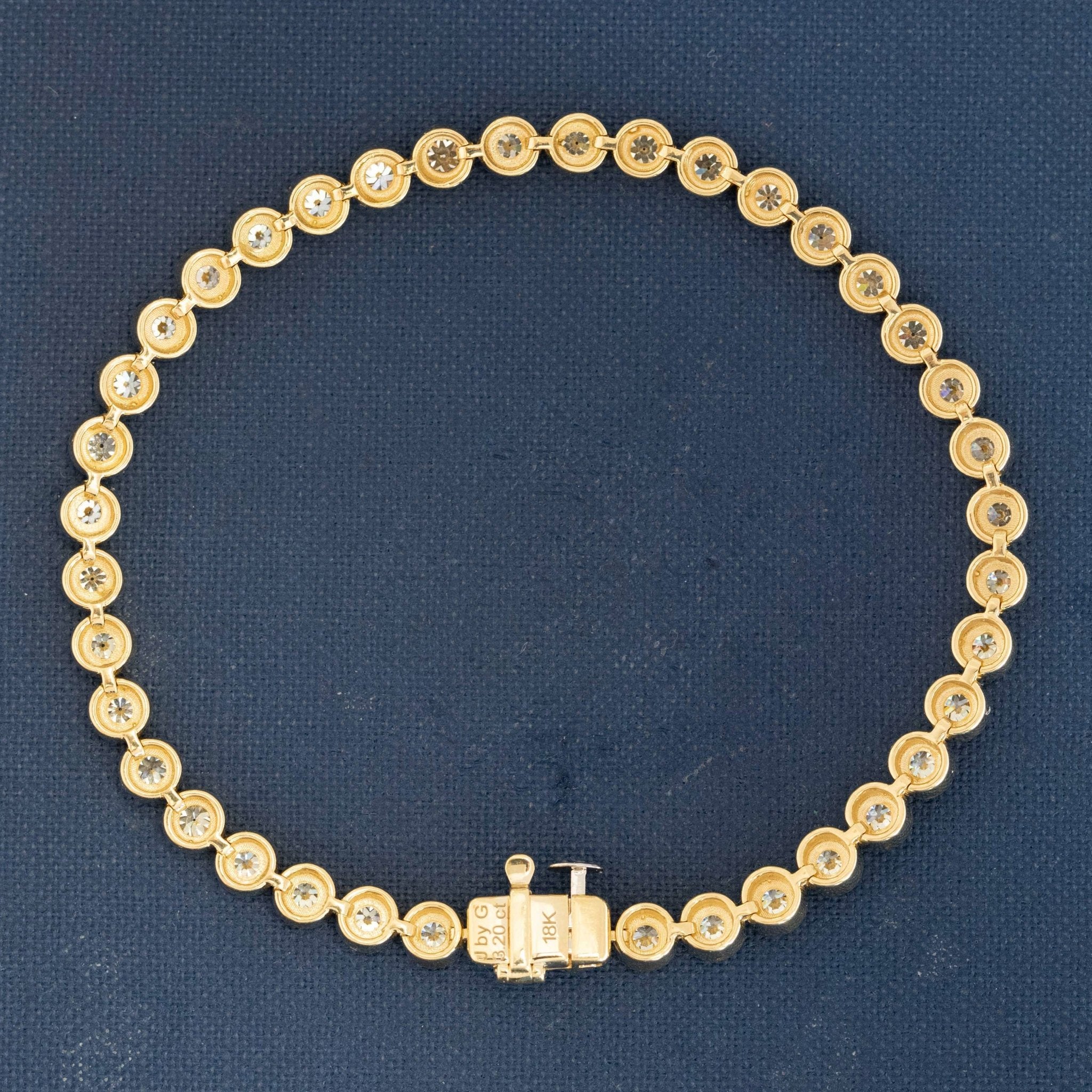 Vintage JbyG tennis bezel bracelet showcasing Old European cuts and gold setting