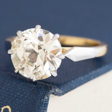 Old Mine Cut Diamond Ring, displayed on a book