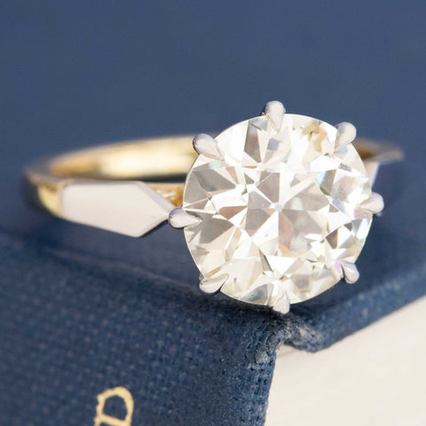 Old Mine Cut Diamond Ring, displayed on a book