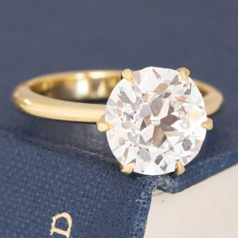 Classic 6-prong yellow gold solitaire with antique diamond.