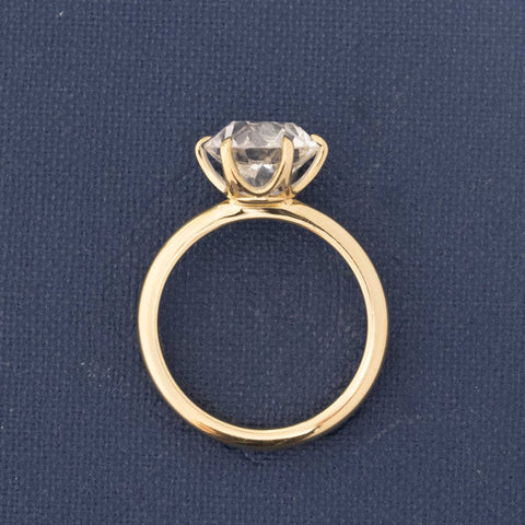 Side profile of low-set 18kt gold Old European diamond ring with broad facets.