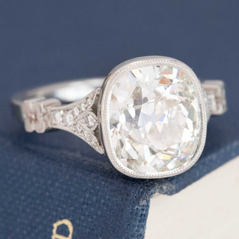 Victor Canera vintage floral motif diamond engagement ring with prismatic sparkle.