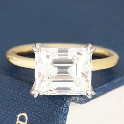 4.08ct Antique Emerald Cut Diamond solitaire in platinum and 18kt yellow gold. GIA certified K VVS2 emerald cut diamond ring with split prong setting.