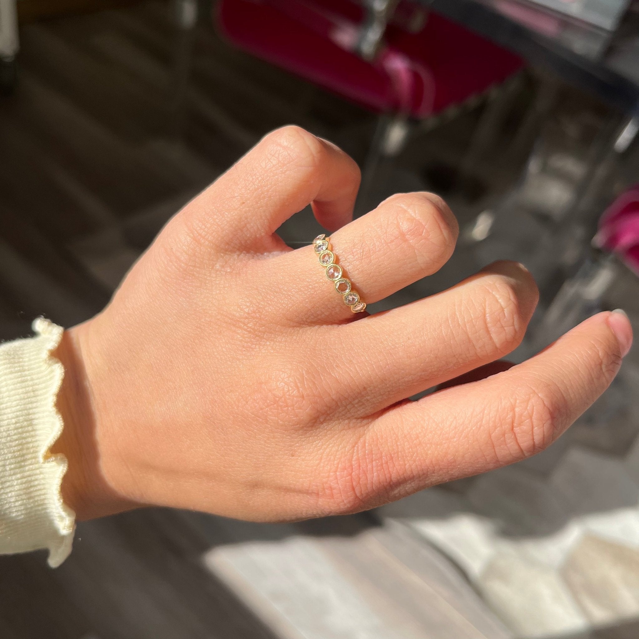 Elegant .47ctw Round Rose Cut Diamond Bezel Half-Hoop Band, romantic design with Antique Diamonds, Earth-mined diamonds in yellow gold shown on ring finger.