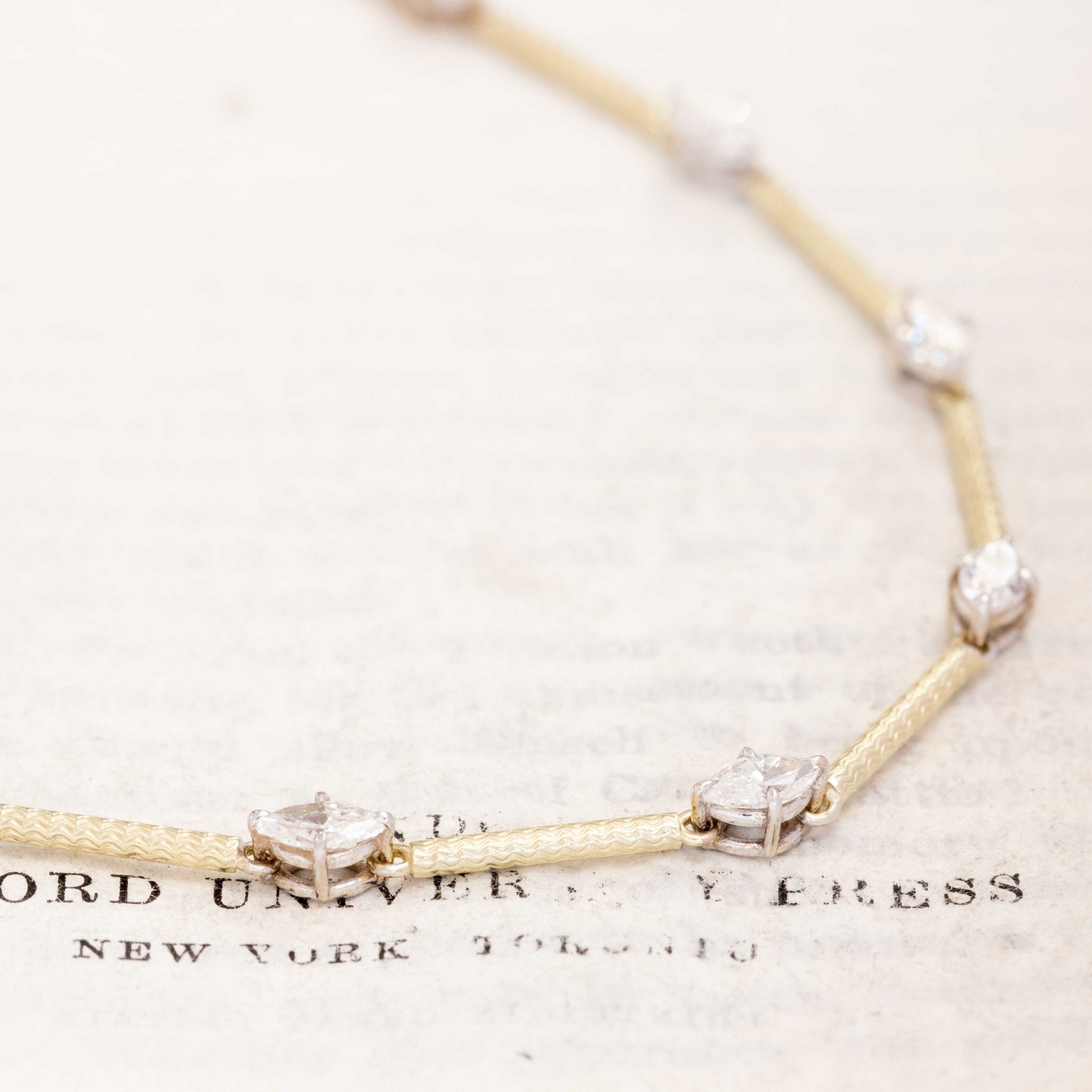 Close-up of marquise diamond station necklace with bar links