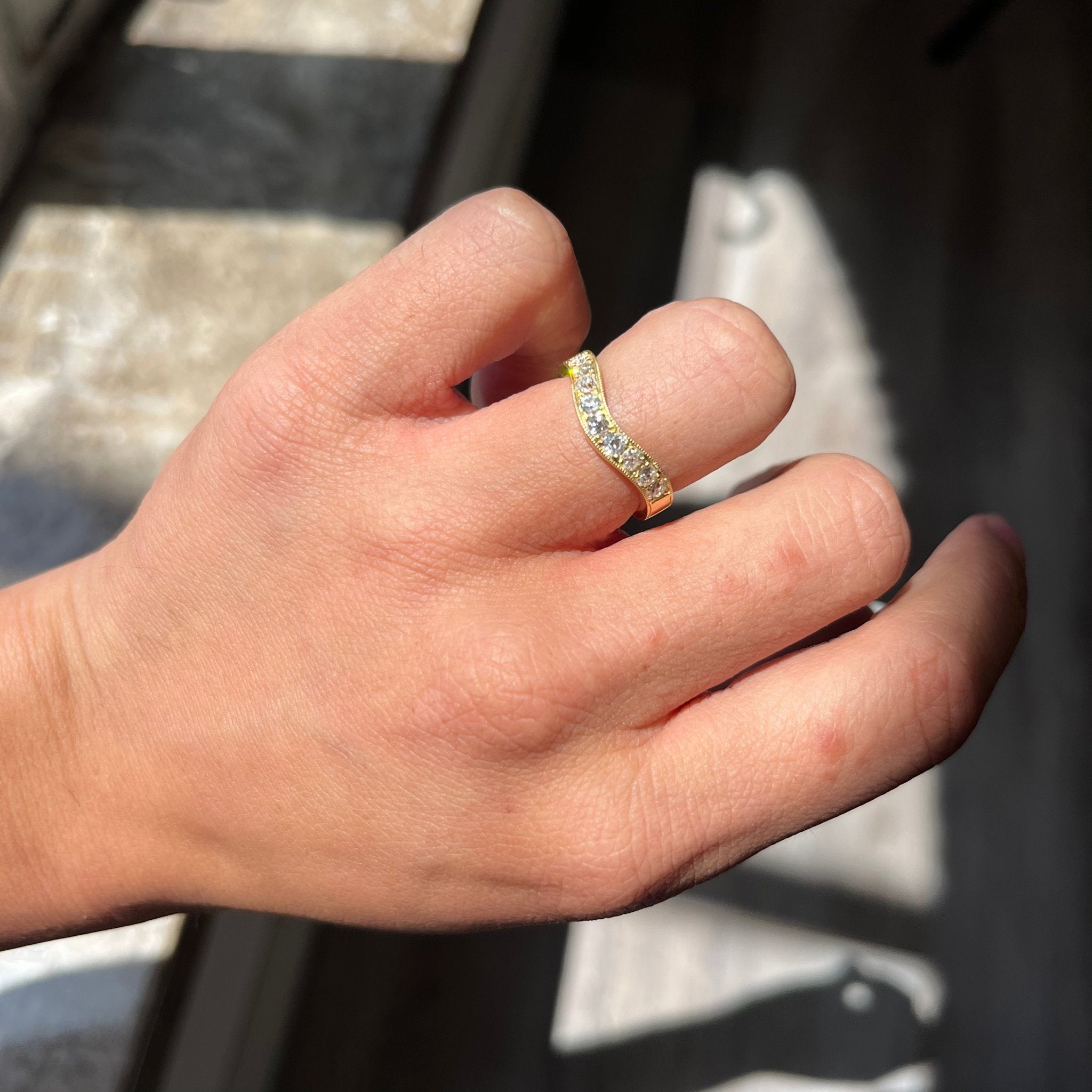 Elegant .49ctw Old European Cut Diamond Curved Band, romantic design with Old European Cut Diamonds, Earth-mined diamonds in yellow gold shown on ring finger.