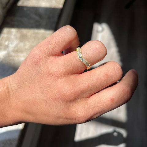 Elegant .49ctw Old European Cut Diamond Curved Band, romantic design with Old European Cut Diamonds, Earth-mined diamonds in yellow gold shown on ring finger.