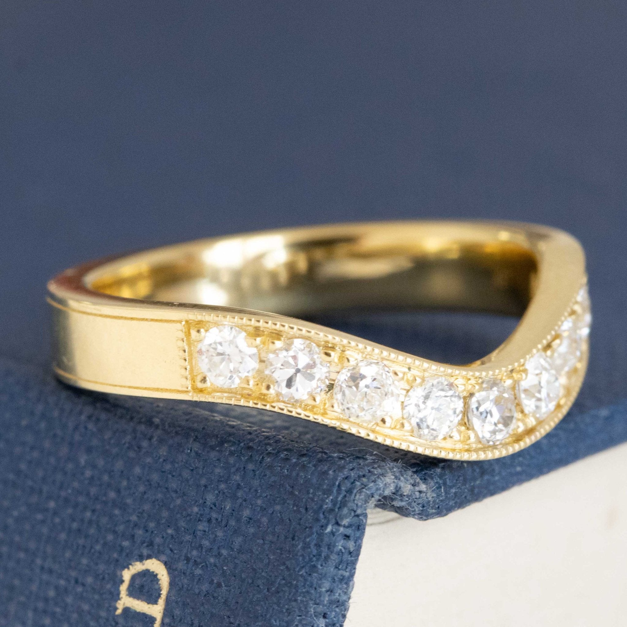 Close-up of .49ctw Old European Cut Diamond Curved Band, vintage-inspired band with Old European Cut Diamonds, crafted in yellow gold.