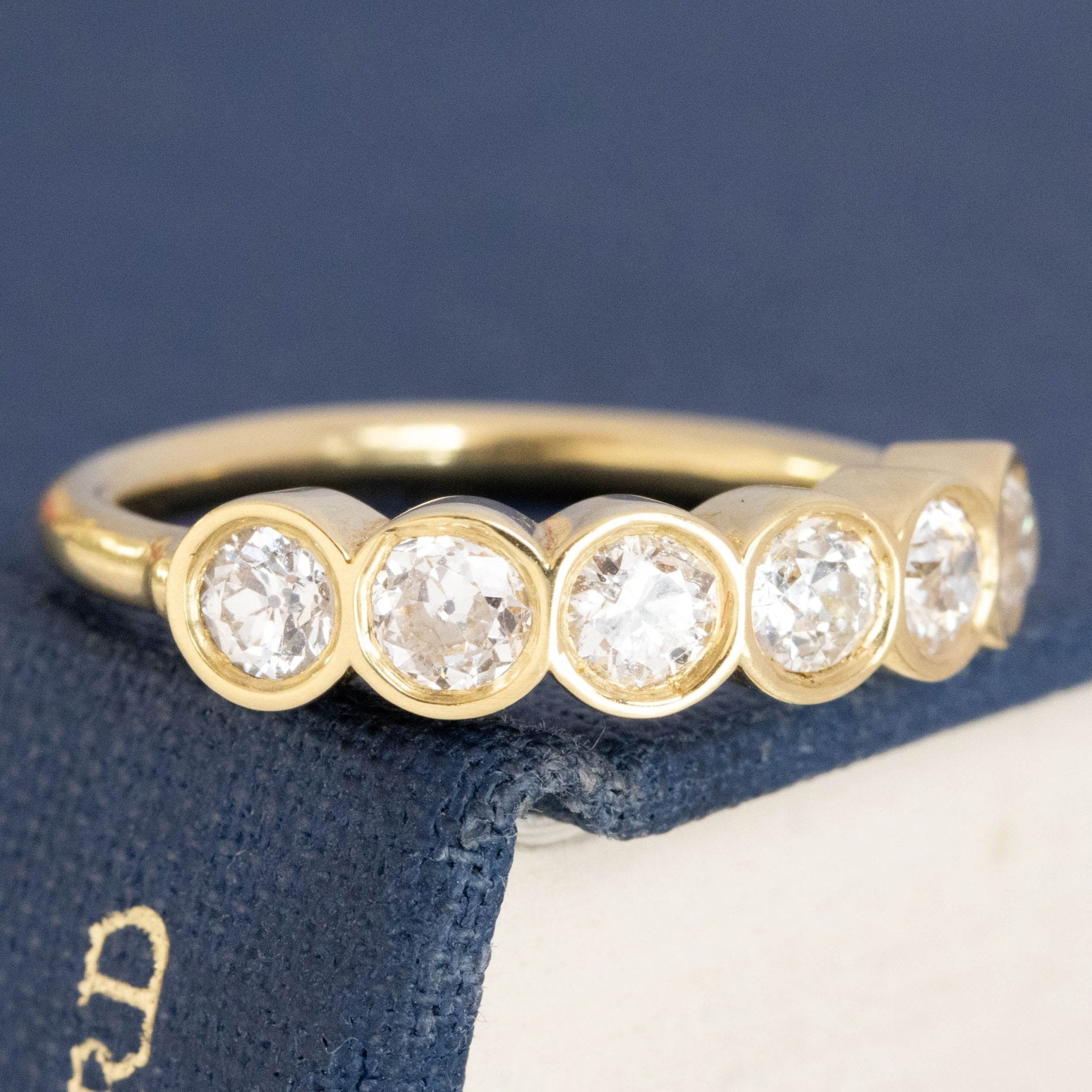 Close-up of .52ctw Old European Cut Diamond 6-Stone Bezel Band, vintage-inspired band with Old European Cut Diamonds, crafted in yellow gold.