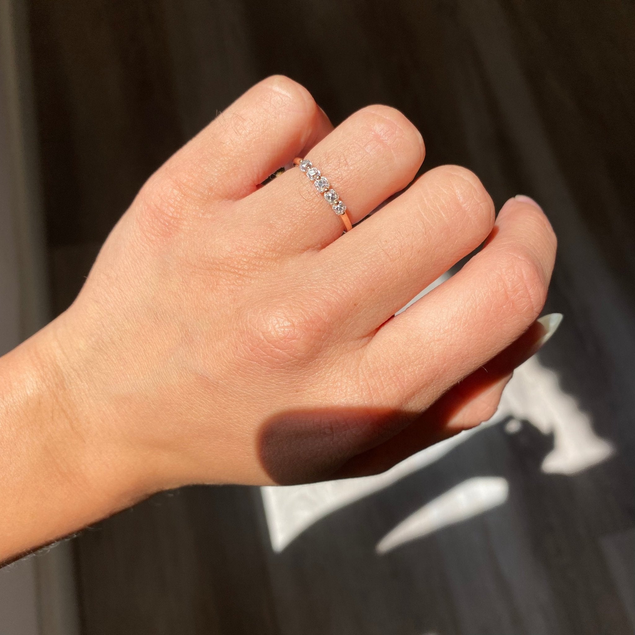 Elegant .53ctw Old Mine Cut Diamond Shared Prong Band, romantic design with Old Mine Cut Diamonds, Earth-mined diamonds in rose gold shown on ring finger.