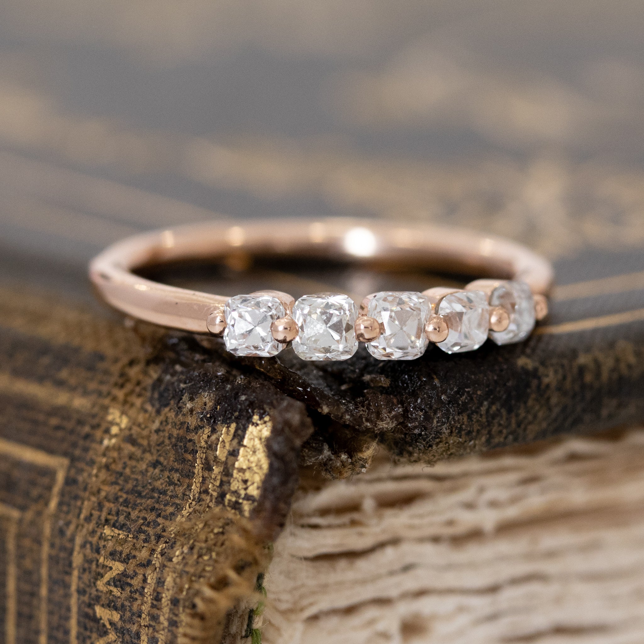 Close-up of .53ctw Old Mine Cut Diamond Shared Prong Band, vintage-inspired band with Old Mine Cut Diamonds, crafted in rose gold.