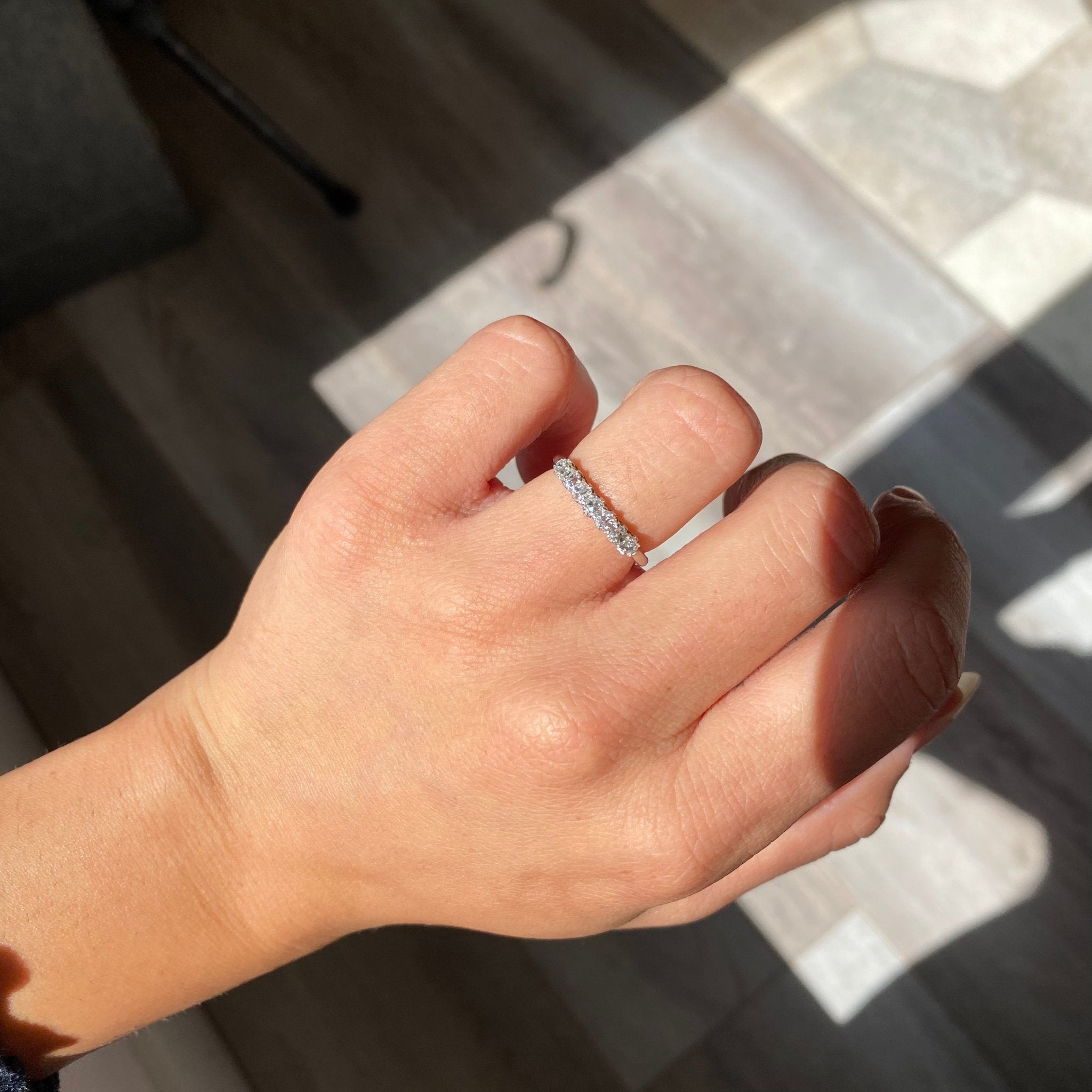 Elegant .53ctw Petite Old Mine Cut Diamond Band, romantic design with Old Mine Cut Diamonds, Earth-mined diamonds in platinum shown on ring finger.