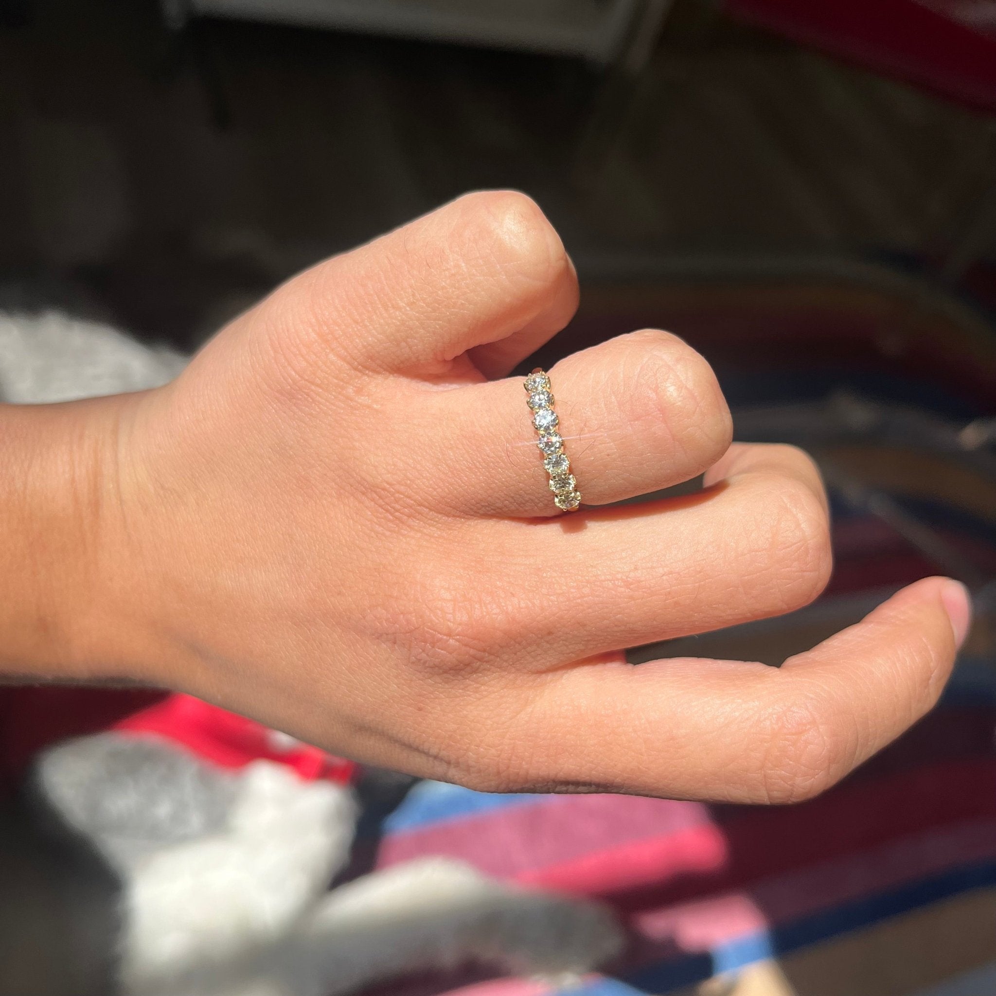 Elegant .54ctw Old European Cut Diamond 7-Stone Band, romantic design with Old European Cut Diamonds, Earth-mined diamonds in yellow gold shown on ring finger.