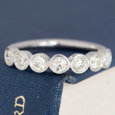 0.54ctw petite old European cut diamond bezel seven-stone band in platinum