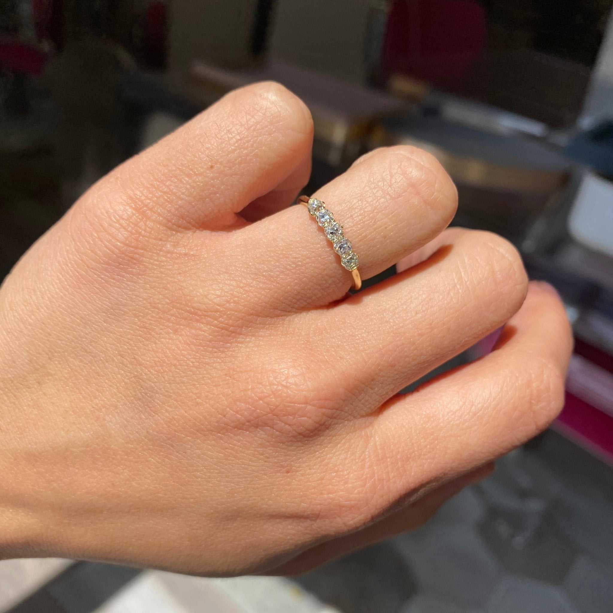 Elegant .55ctw Petite Old Mine Cut Diamond 5-Stone Band, romantic design with Old Mine Cut Diamonds, Earth-mined diamonds in yellow gold shown on ring finger.