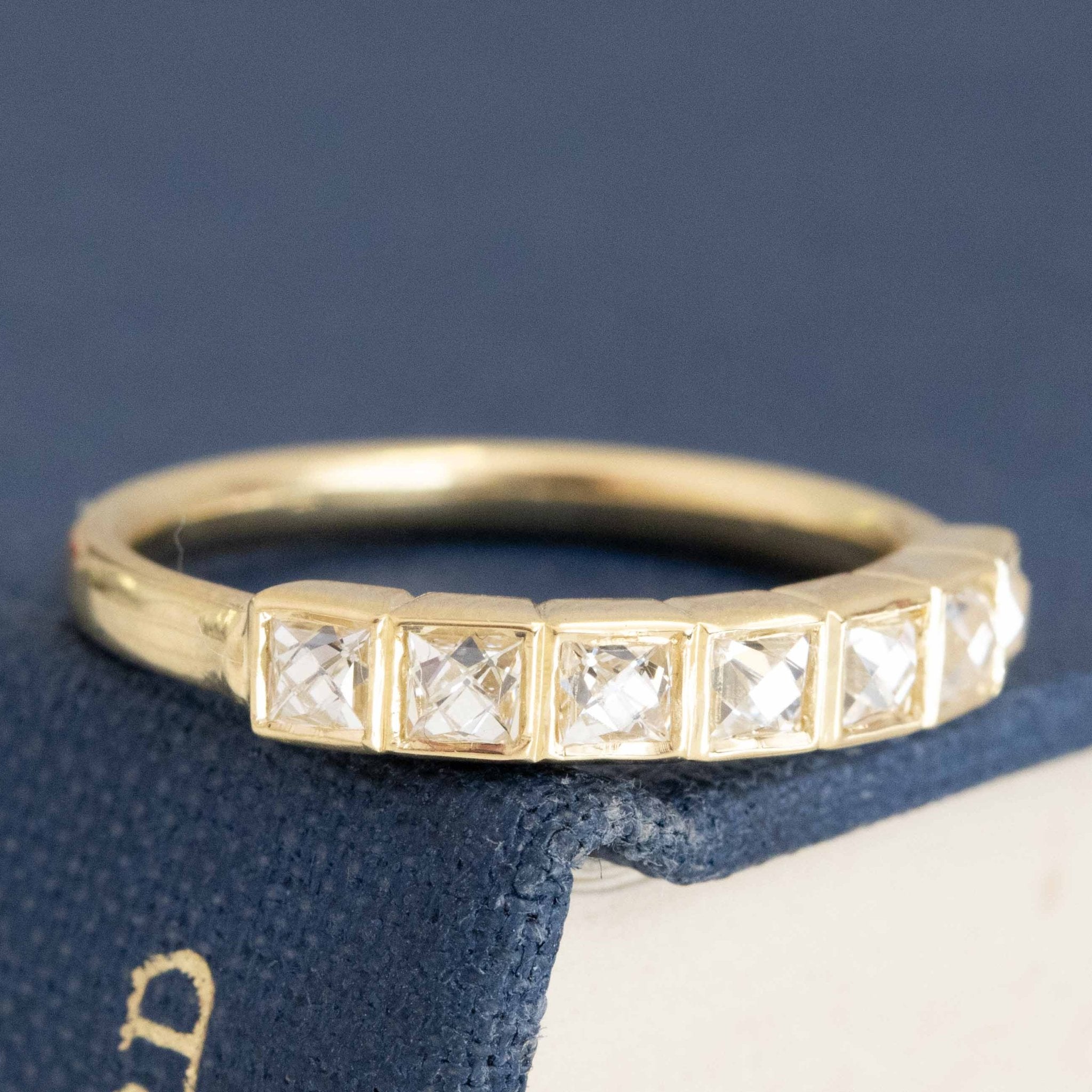 Close-up of .57ctw French Cut Diamond Bezel Band, vintage-inspired band with French Cut Diamonds, crafted in yellow gold.