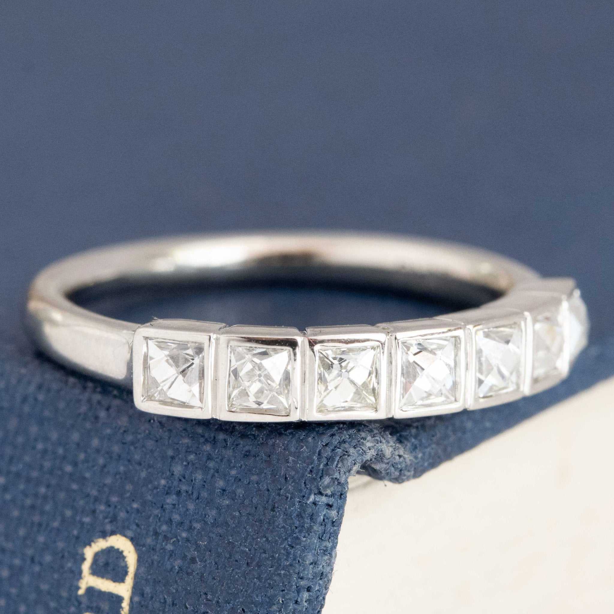 Close-up of .58ctw French Cut Diamond Half-Hoop Bezel Band, vintage-inspired band with French Cut Diamonds, crafted in platinum.