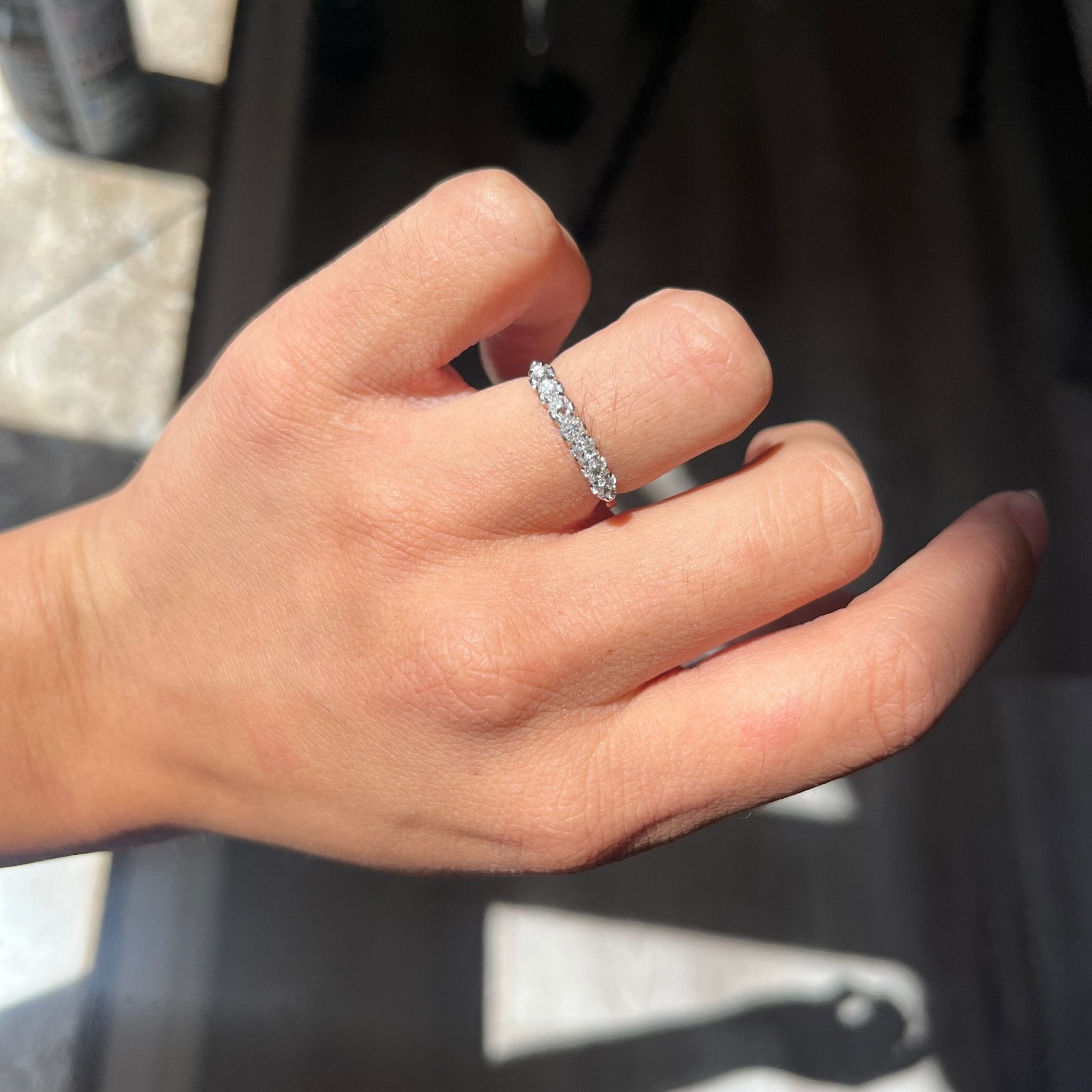 Elegant .58ctw Petite Old Mine Cut Diamond Half-Hoop Band, romantic design with Old Mine Cut Diamonds, Earth-mined diamonds in platinum shown on ring finger.