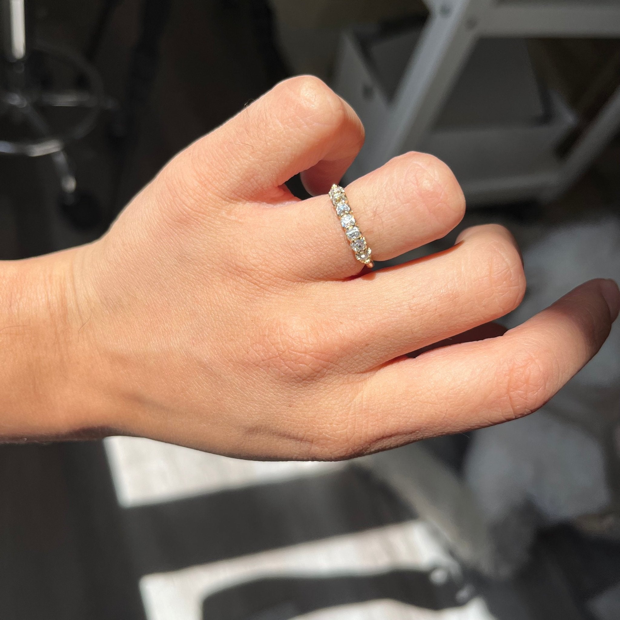 Elegant .58ctw Petite Old Mine Cut Diamond Half-Hoop Band, romantic design with Old Mine Cut Diamonds, Earth-mined diamonds in yellow gold shown on ring finger.