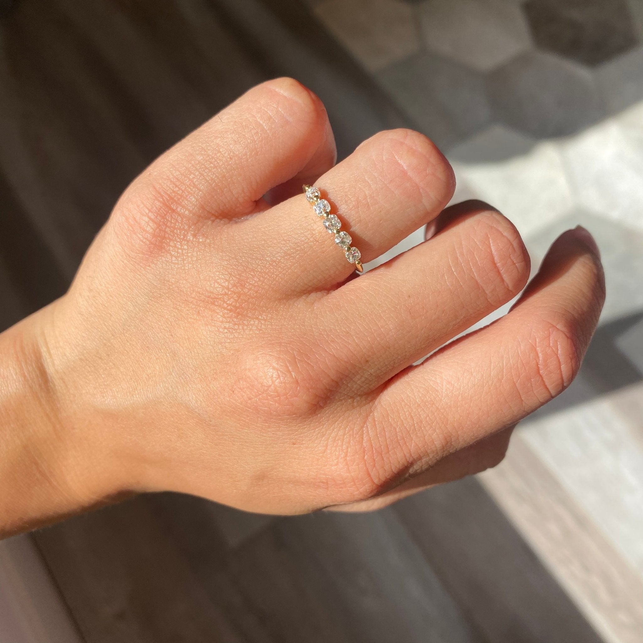 Elegant .58ctw Petite Old Mine Cut Diamond Shared Prong Band, romantic design with Old Mine Cut Diamonds, Earth-mined diamonds in yellow gold shown on ring finger.